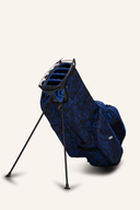 Ogio All Elements Hybrid Standbag mit mehreren Fächern und ergonomischem Tragegriff auf einem Golfplatz.